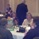 Image of conference attendees at a table